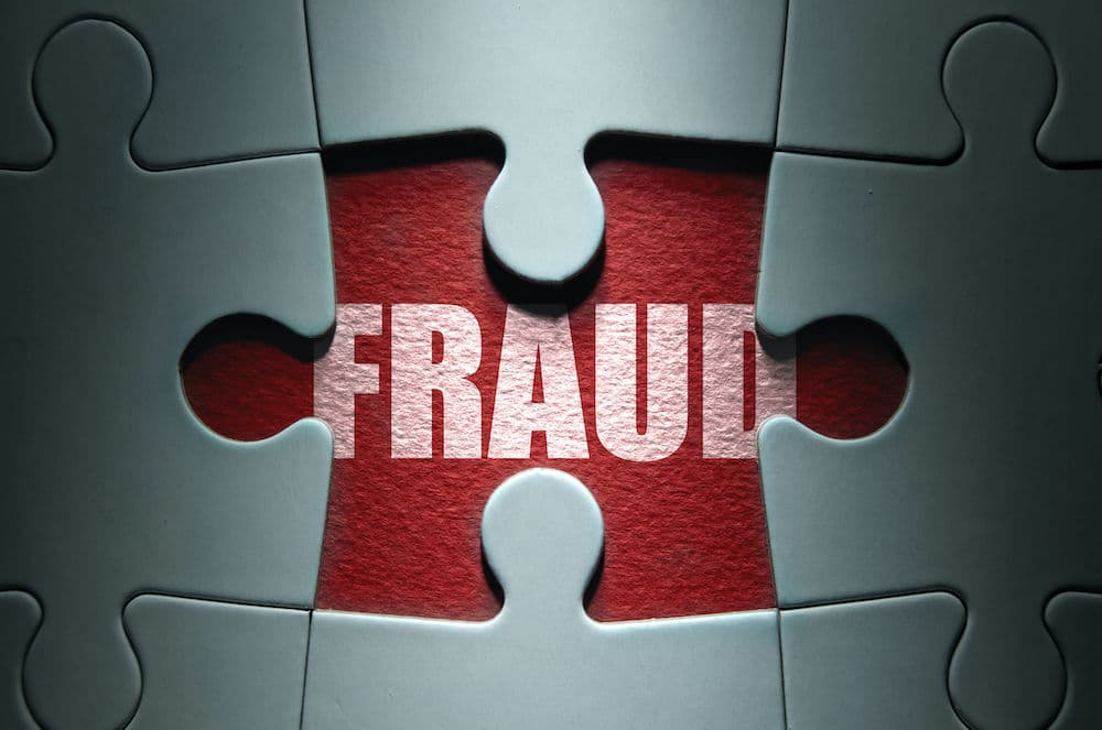 The word Fraud under jigsaw pieces 