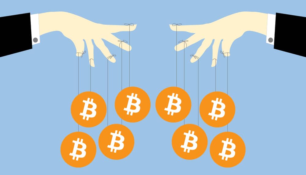 Art of two hands holding bitcoins by string