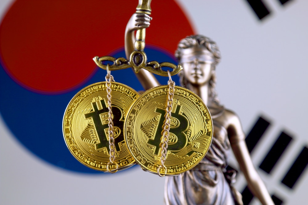 Lady Justice holding two bitcoins instead of scales, in front of South Korean flag