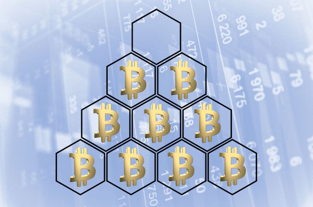 Bitcoin logos in hexagons making up a small pyramid