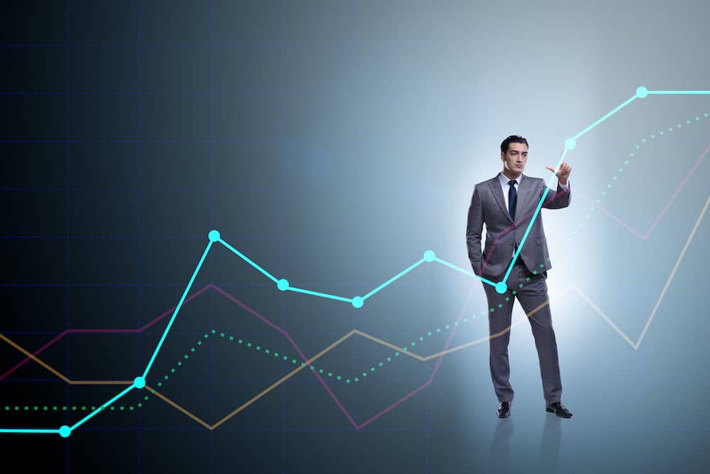 Man pointing at points in a line graph