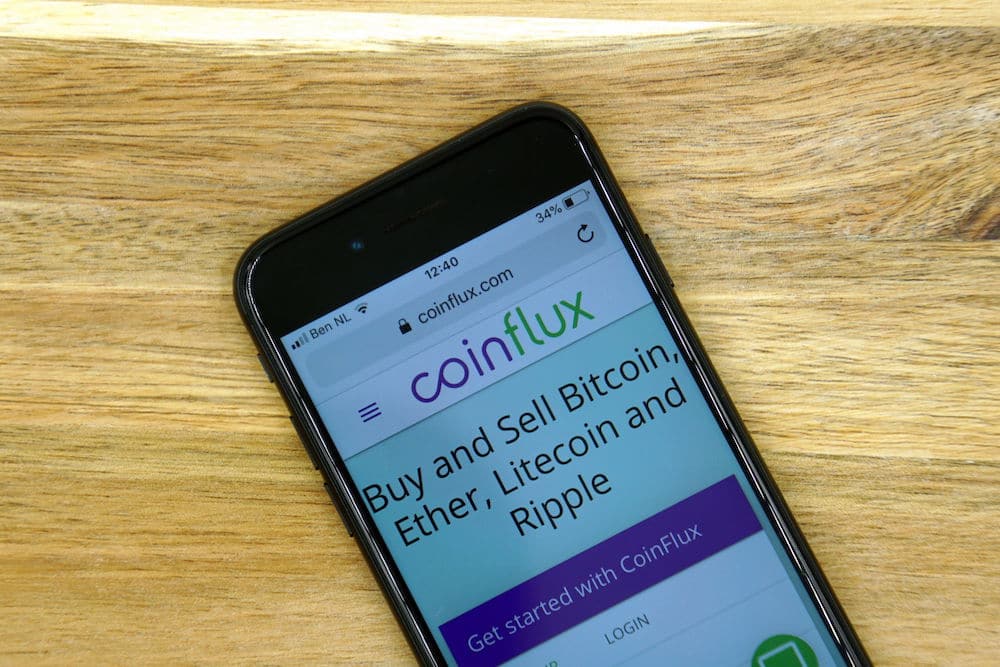 Coinflux website homepage on a phone screen