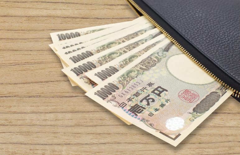 Japanese 10000 Yen Bills sitting out of a wallet