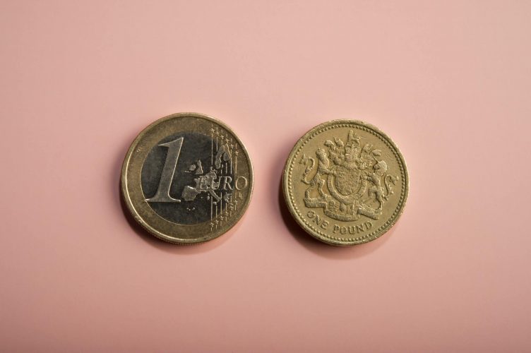 1 Euro and 1 GBP Coins next to eachother 