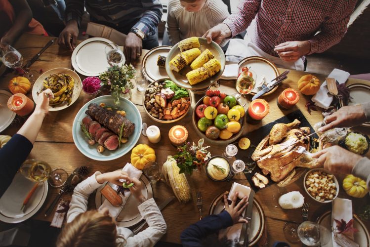 People sitting around a table with a large amount of food 