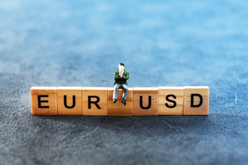toy blocks with letters which read EURUSD with a toy man sitting on top