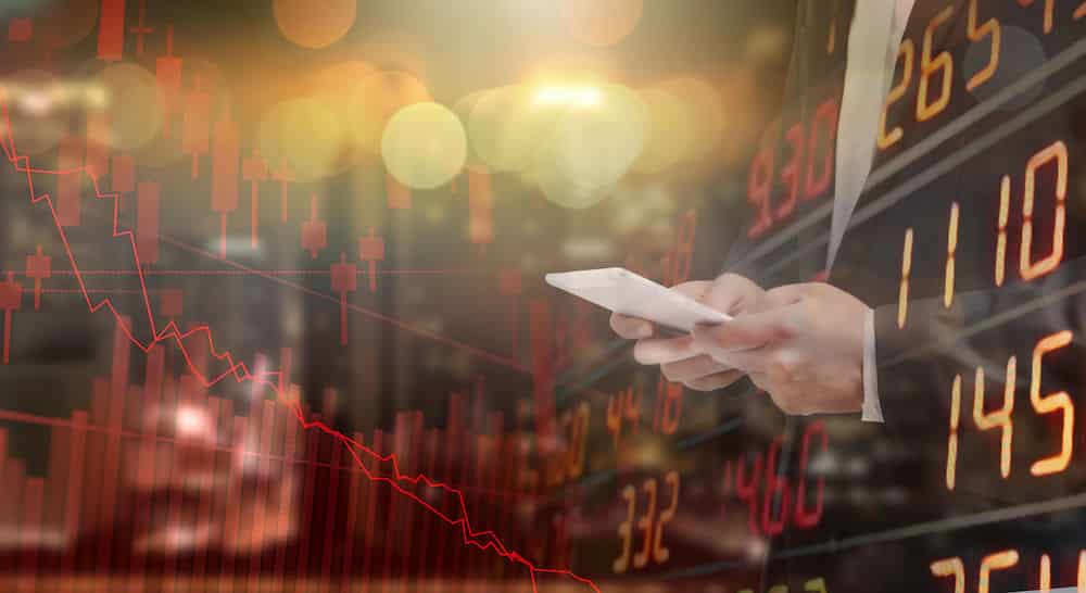 Man Using Phone Surrounded By Stock Market Information