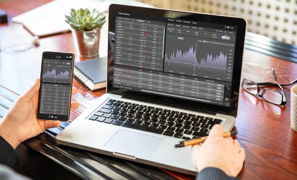 Phone and Laptop showing a Forex Trading Graph